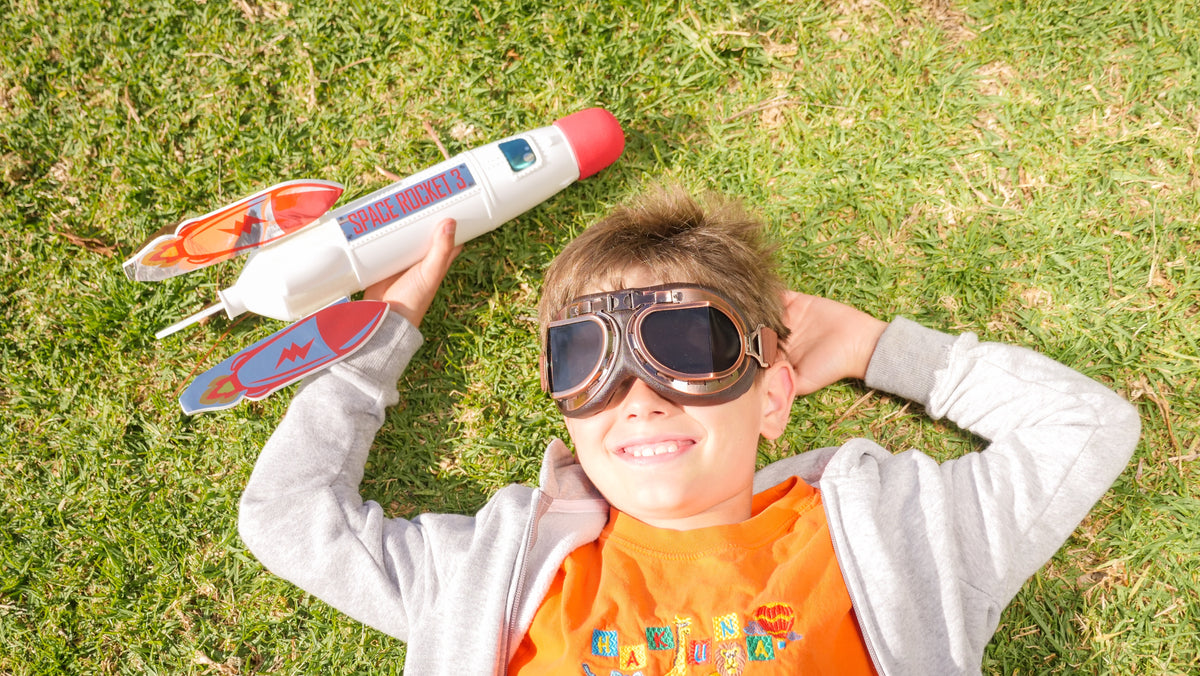 Young boy having a blast with his bottle rocket lab kit